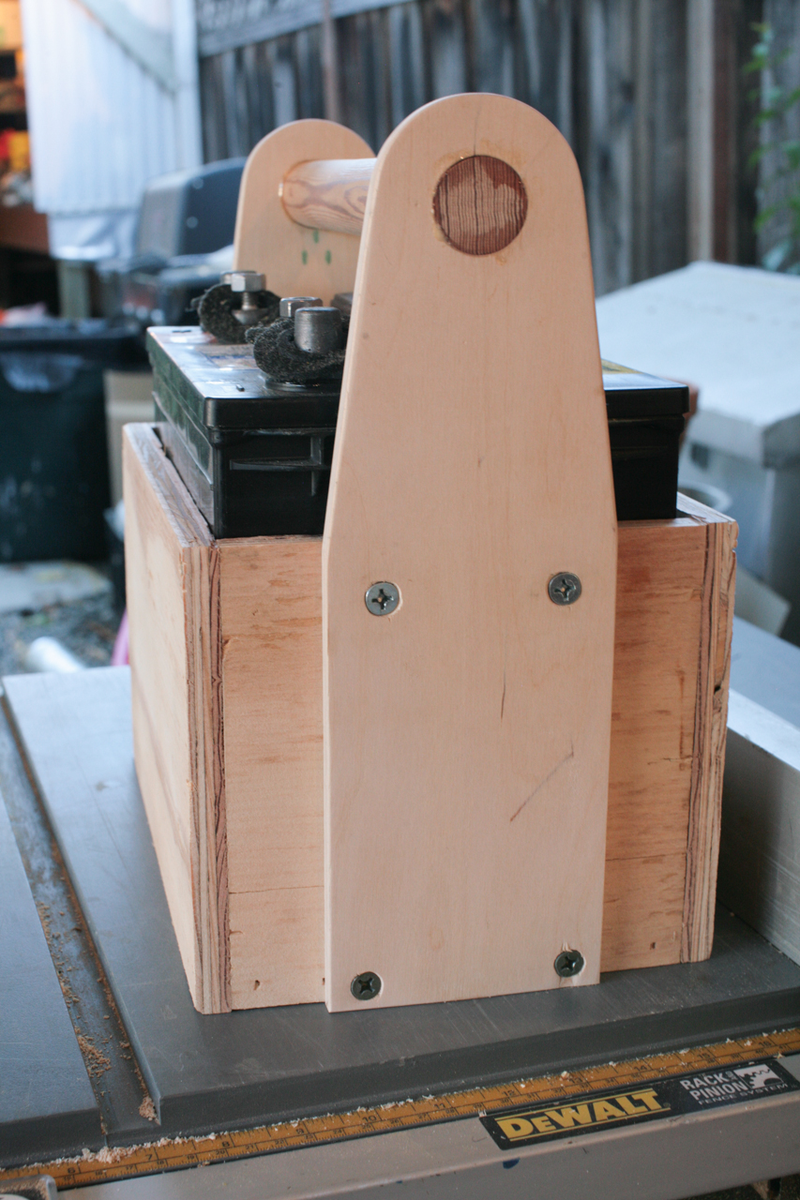 T-nuts at the top and 1/4 x 2-1/2 Spax at the bottom. You have to install the caddy onto the battery.
